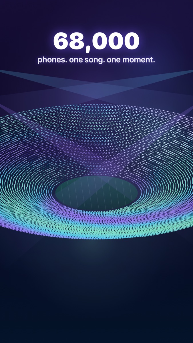 A stadium bowl lit by thousands of phone screens in sync